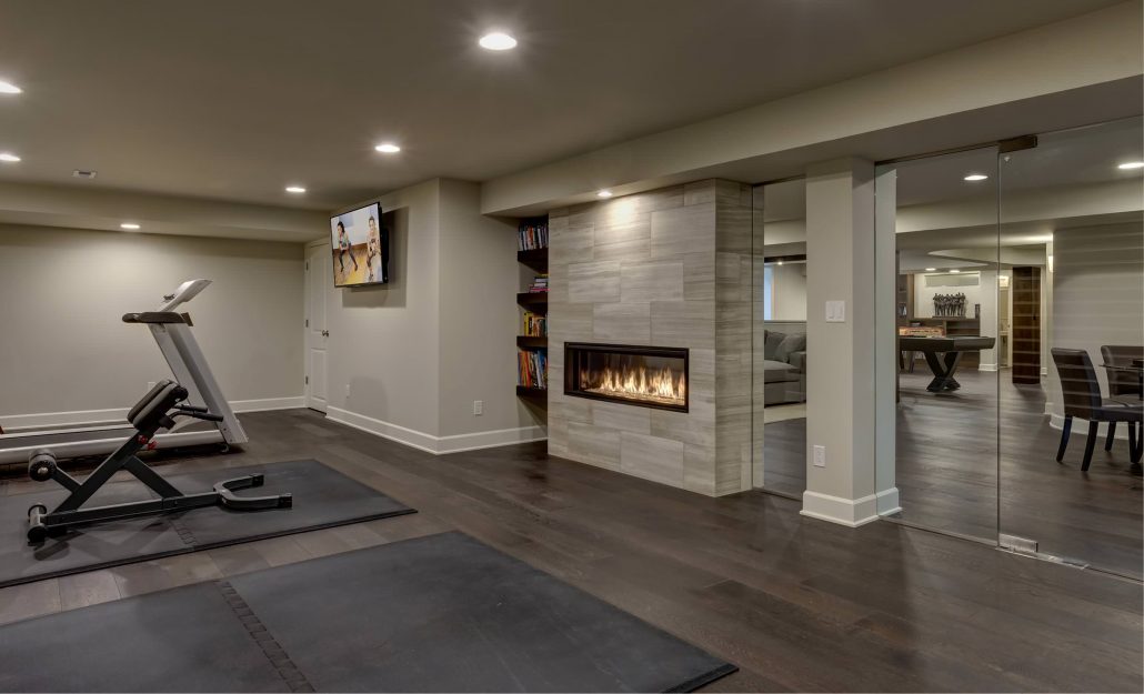 basement exercise room with fireplace
