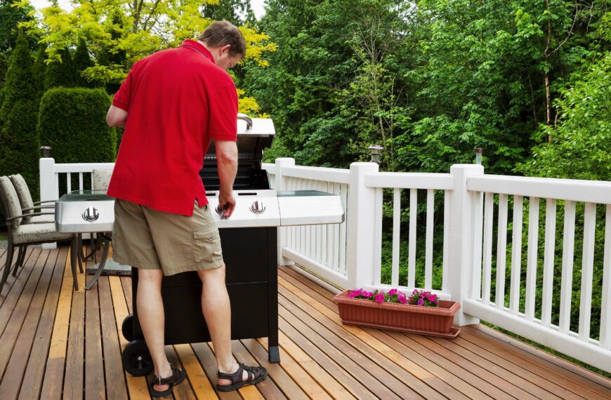 Mature man turning on barbecue grill
